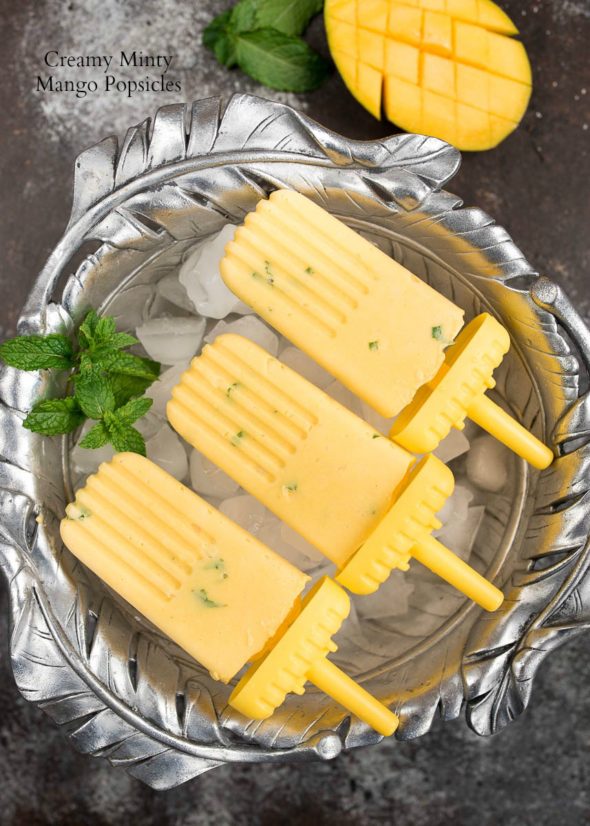 Creamy Minty Mango Popsicles- these lower sugar, simple 4 ingredient pops can be assembled in minutes and make a healthy treat! | www.nutritiouseats.com