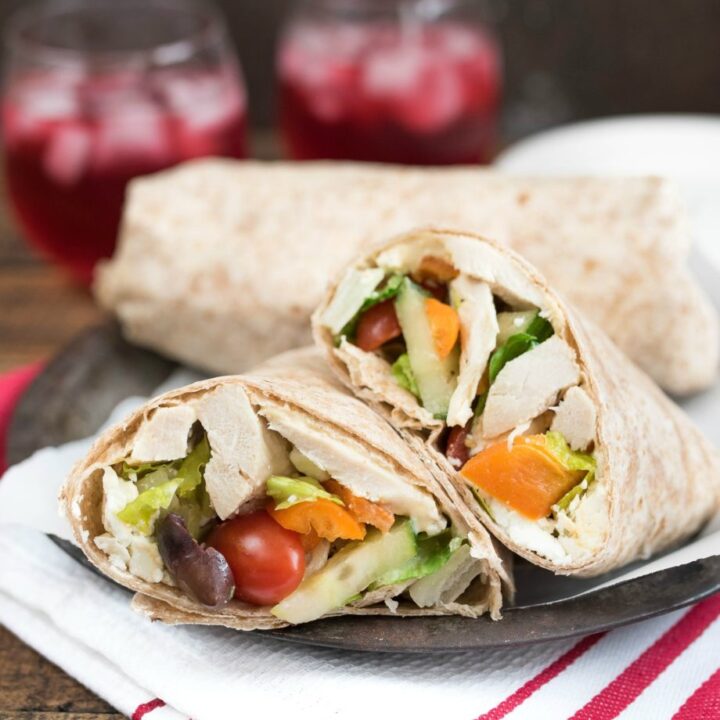 Mediterranean Chicken Wrap- Greek Salad, hummus and seasoned chicken make up this tasty wrap. Great for leftovers or a make-ahead meal! | www.nutritiouseats.com