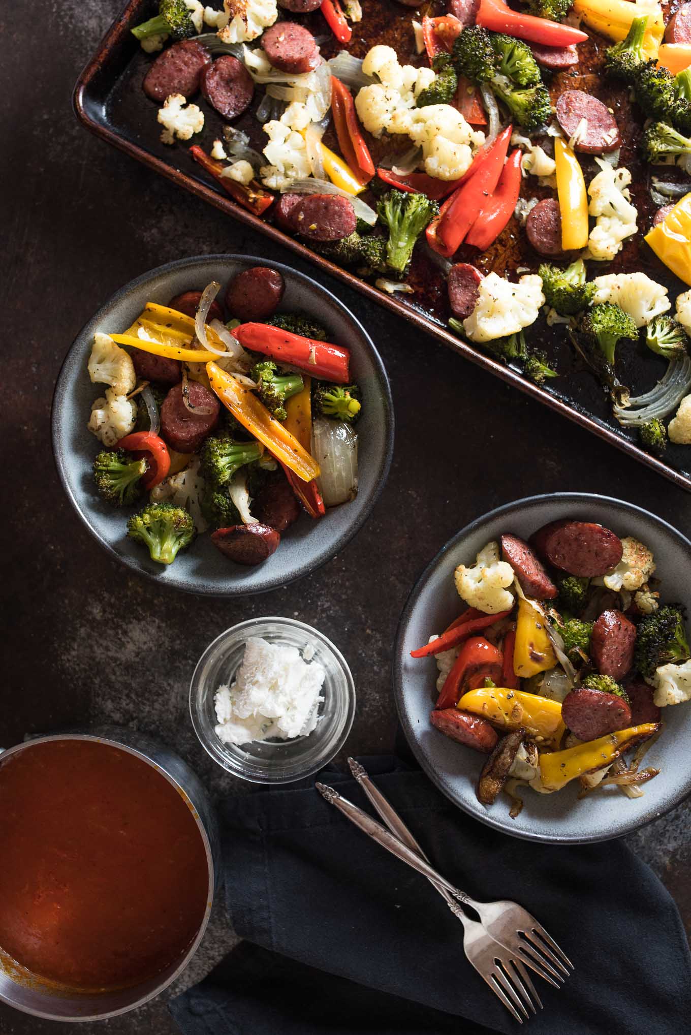 One Pan Roasted Sausage and Vegetables with Marinara and Goat Cheese is low calorie, gluten free and the answer to your dinner dilemma since it only takes a few minutes to prepare and the frees up time while it bakes in the oven.