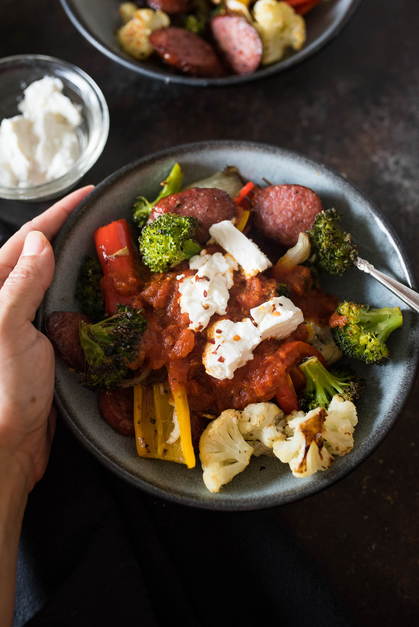 One Pan Roasted Sausage and Vegetables with Marinara and Goat Cheese is low calorie, gluten free and the answer to your dinner dilemma since it only takes a few minutes to prepare and the frees up time while it bakes in the oven.