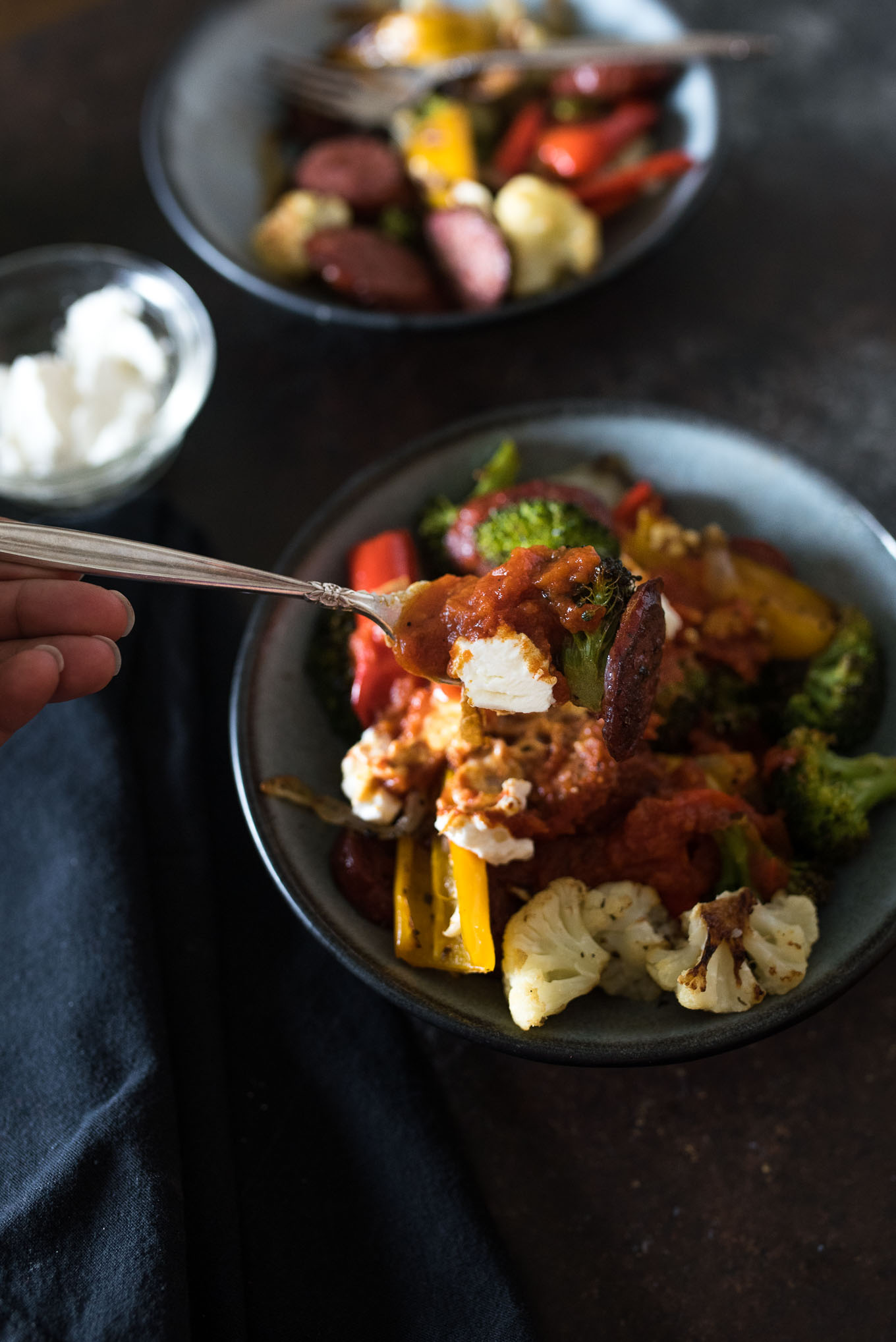 One Pan Roasted Sausage and Vegetables with Marinara and Goat Cheese is low calorie, gluten free and the answer to your dinner dilemma since it only takes a few minutes to prepare and the frees up time while it bakes in the oven.