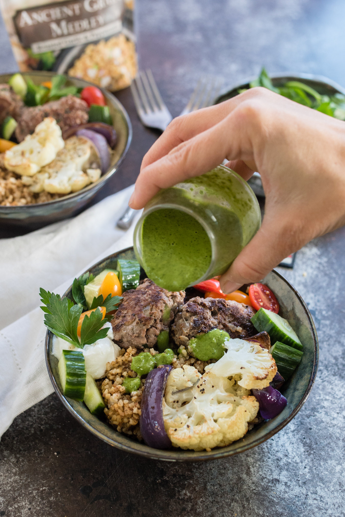 This Beef and Grain Kofta bowl takes Middle Eastern inspired meatballs and pairs them with a hearty flavorful grain and some veggies for a nutrition packed meal!