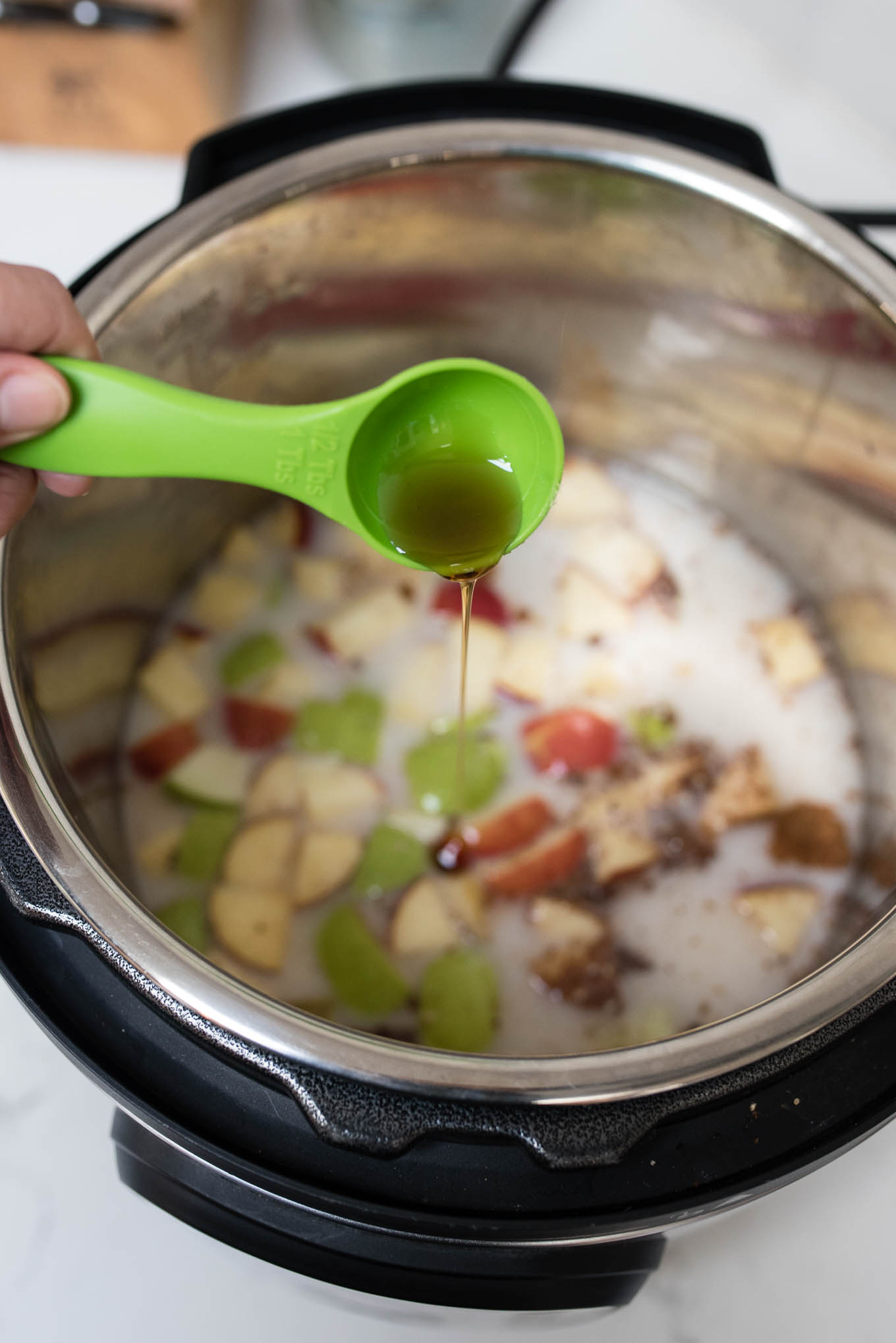 Pouring maple syrup into Instant Pot Oatmeal