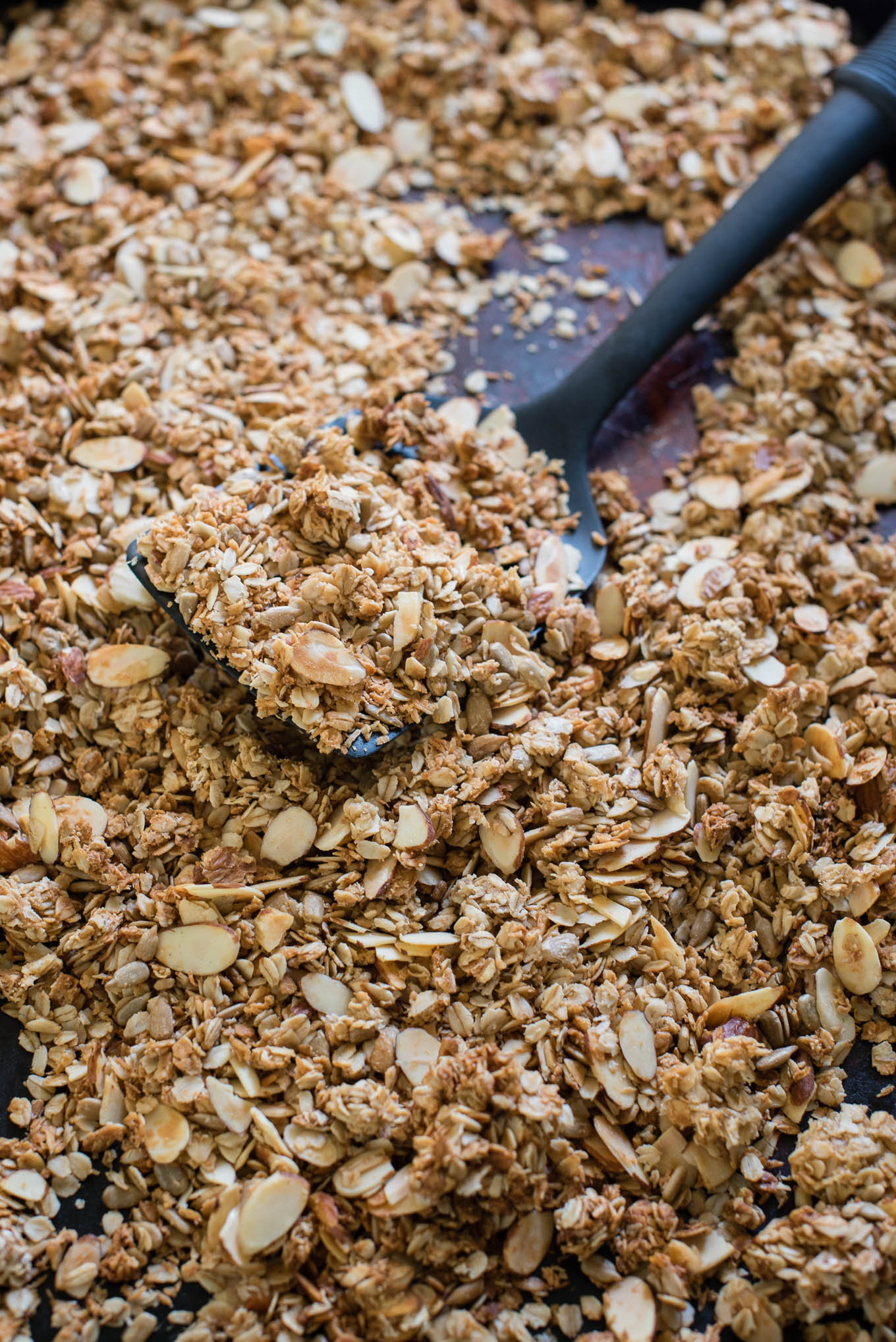 Serve this Easy Homemade Granola with milk, over Greek yogurt or straight from the tin for a healthy breakfast or snack! Made with rolled oats, coconut, seeds, nuts and fruit- the perfect combo! 