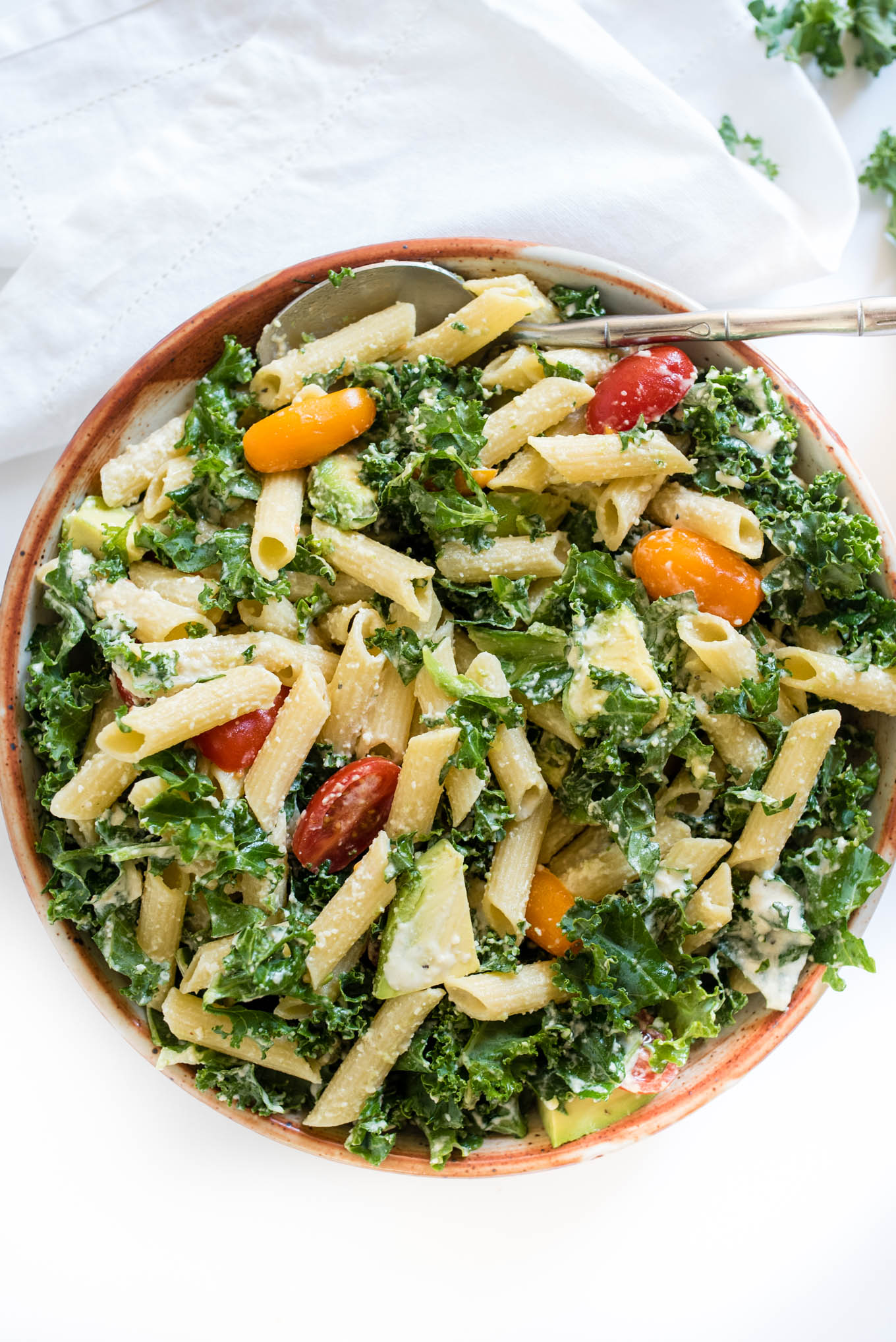 Kale Caesar Pasta Salad is a great vegetarian pasta salad packed with kale, avocado and a simple homemade Caesar dressing. 