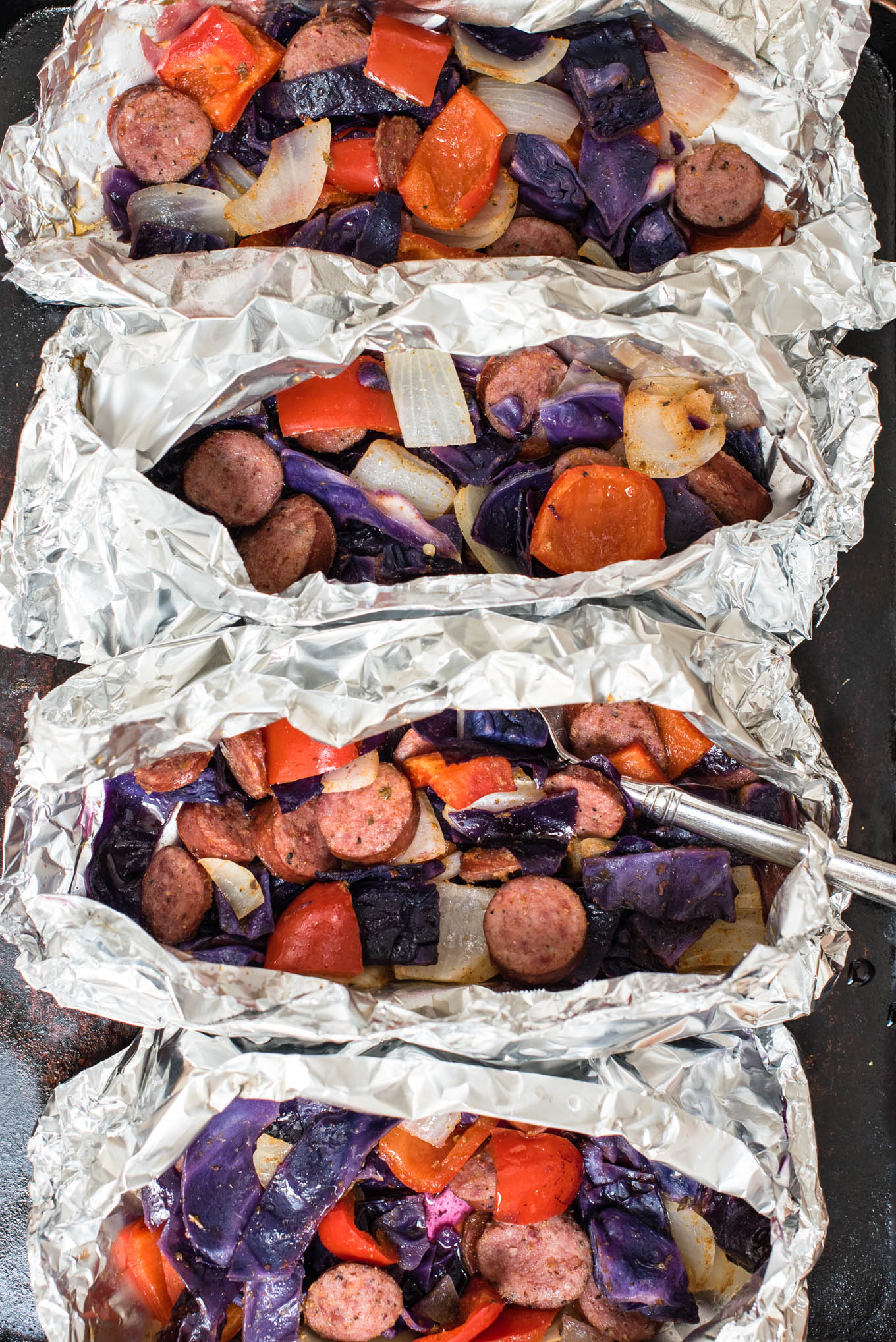Cajun Sausage and Vegetable Foil Packets can be assembled in less than 10 minutes, and are protein rich, fiber packed and gluten free. 