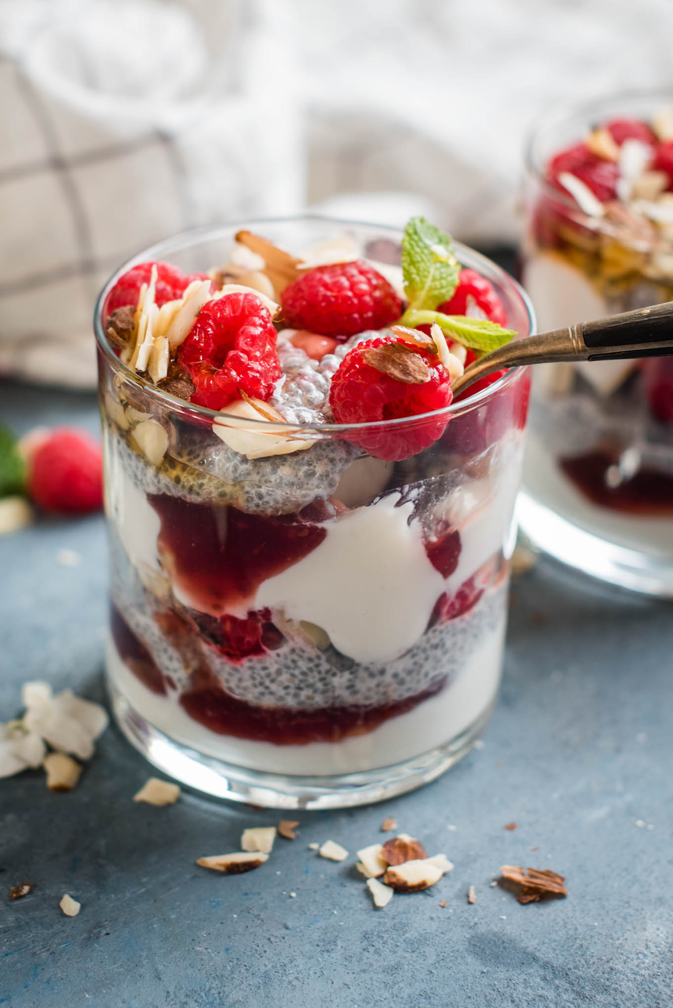Raspberry Chia Parfait with a spoon in the cup 