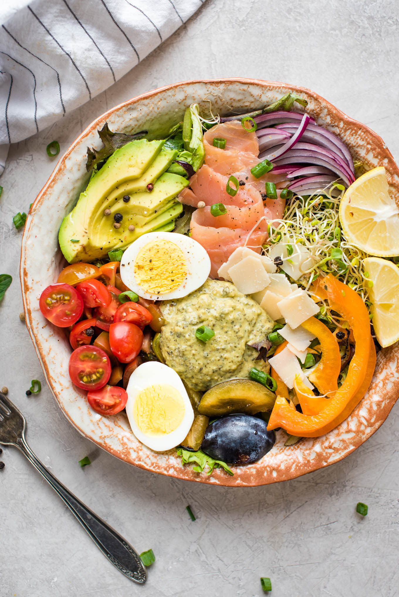 Bowl of vegetables, hummus, egg, salmon 