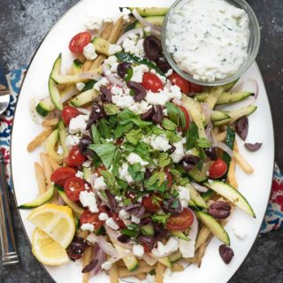 Loaded Mediterranean Fries- Truffle Fries loaded with veggies and Mediterranean flavors like feta, oregano and tzatziki sauce #glutenfree #vegetarian | www.nutritiouseats.com