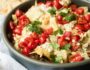 Mediterranean Nachos are a delicious gluten free and vegetarian snack/appetizer loaded with hummus, veggies, feta and more- a fun spin on the classic Tex Mex dish.