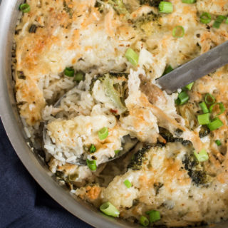 Skillet with a spoon of chicken and rice
